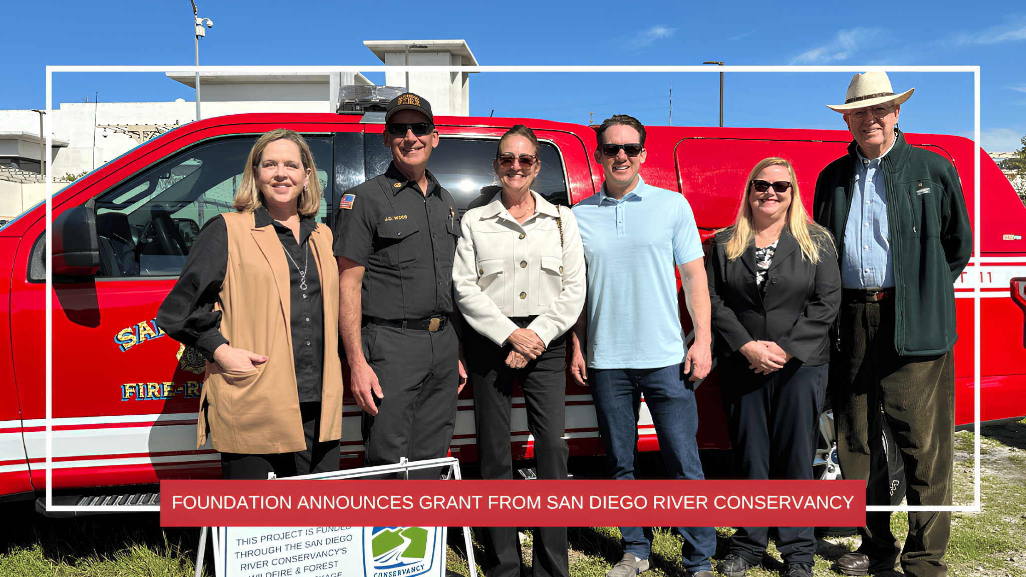 Picture of 6 people standing in front of a red truck
